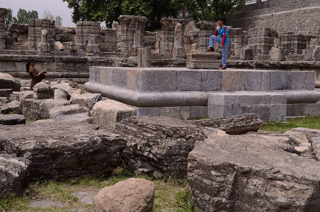 Tourists roam around the ruins
